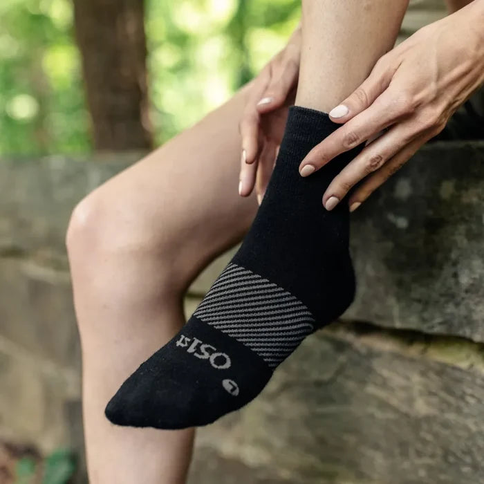 person wearing black wicked comfort merino wool performance sock 1/4 crew length in the woods | OS1st